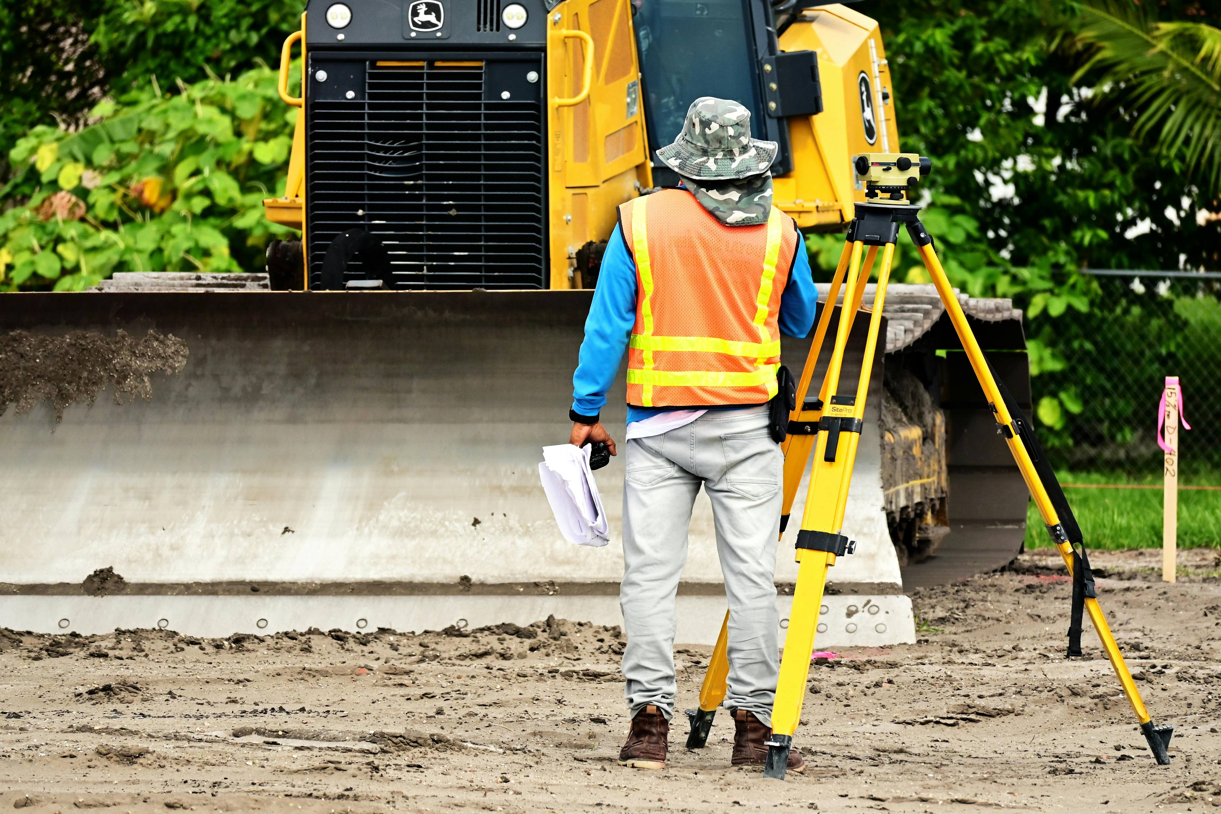 Professional surveyor using advanced surveying equipment at construction site